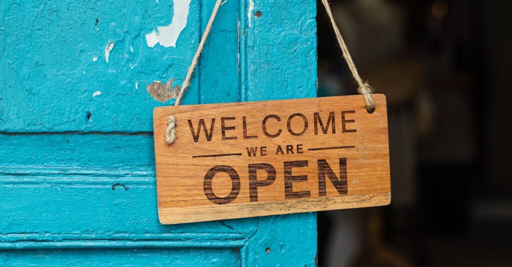 A rustic wooden 'Welcome We Are Open' sign hanging on a vibrant blue door.